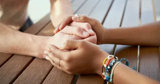 someone holding the hands of another