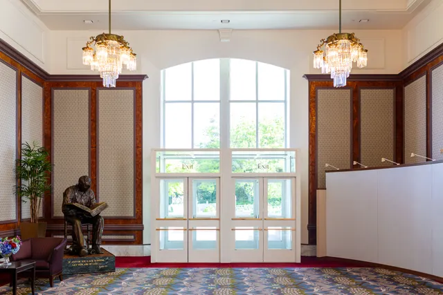 Legacy Theater exit doors and Joseph Smith reading from Bible statue.