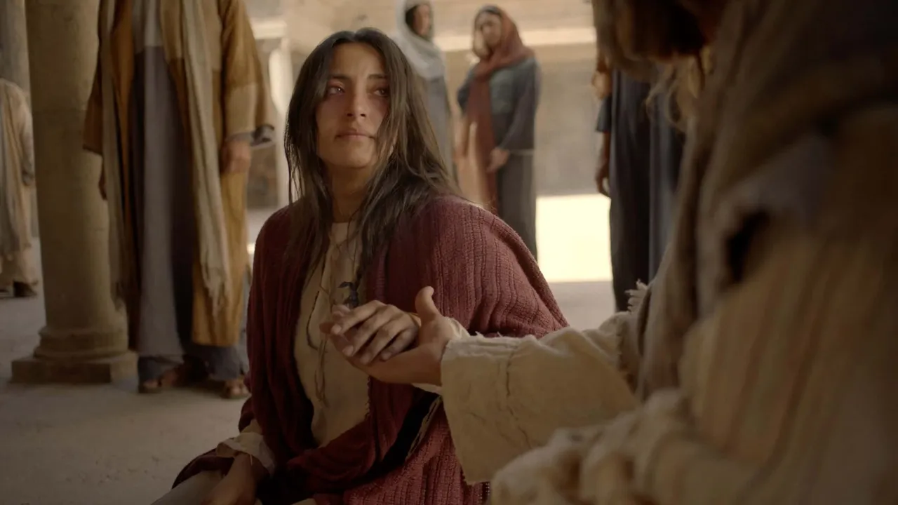 Jesus Christ helps a woman off the ground forgiving her of her sins