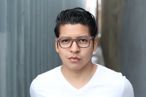 Young man with glasses staring seriously