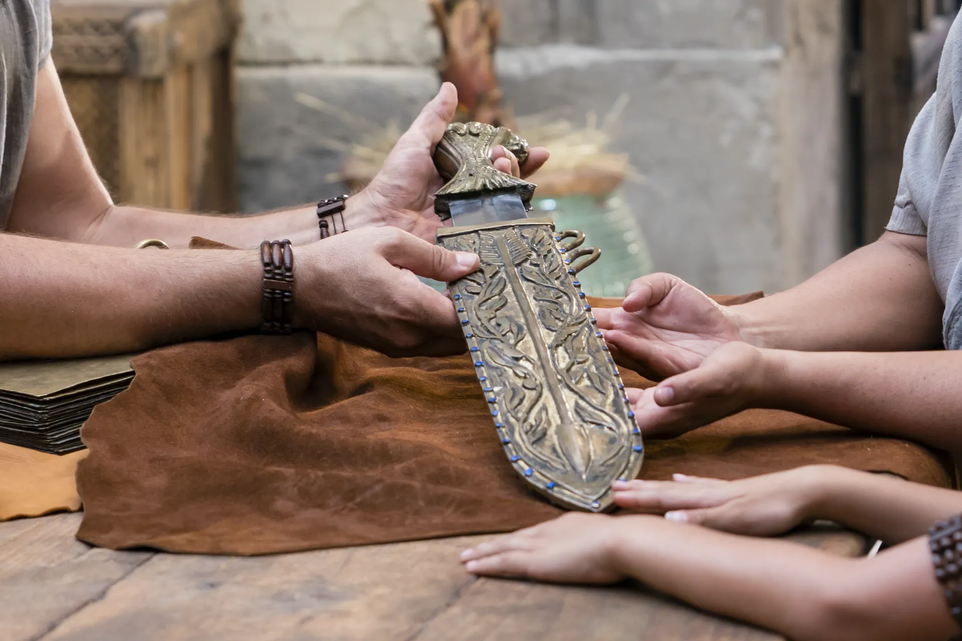 King Benjamin gathers with his family around a table in the Land of Zarahemla and tells them he can no longer be king. He shows his family the sword of Laban.