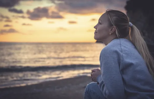 young woman looking off into the sunset