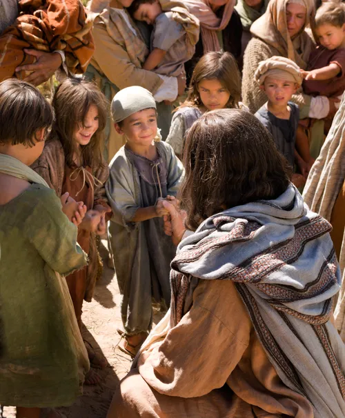 Jesus Christ, surrounded by a group of children, shows them love and compassion