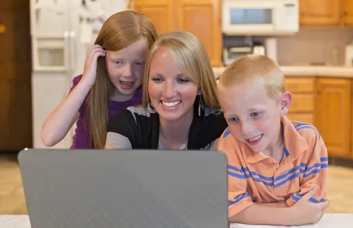 mother and children around computer