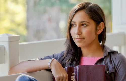 young woman holding scriptures