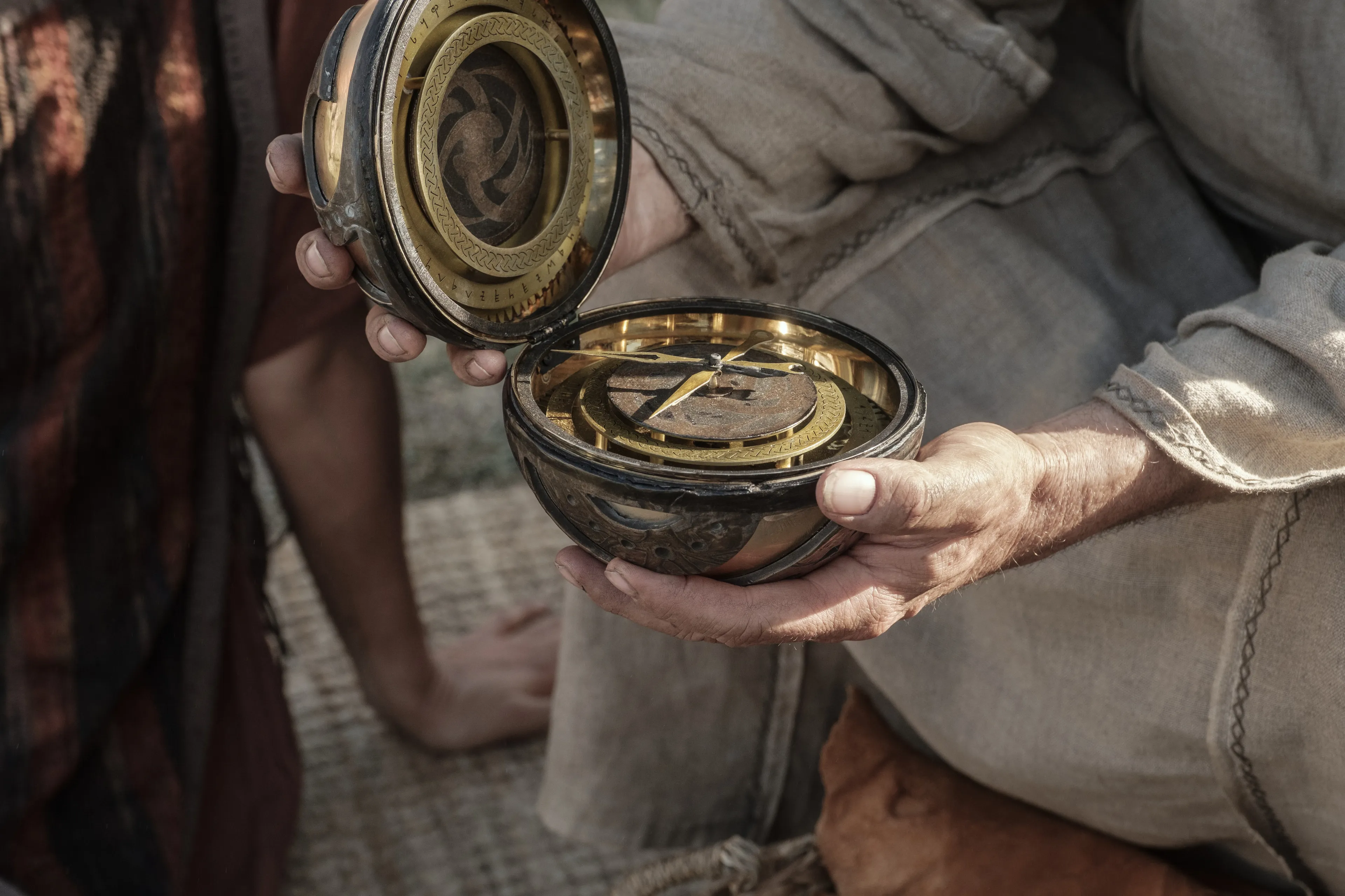 Lehi holds the Liahona in the wilderness.