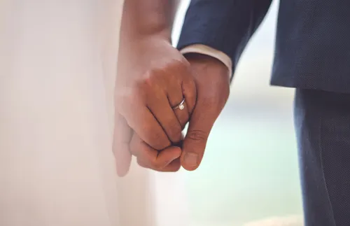 bride and groom holding hands
