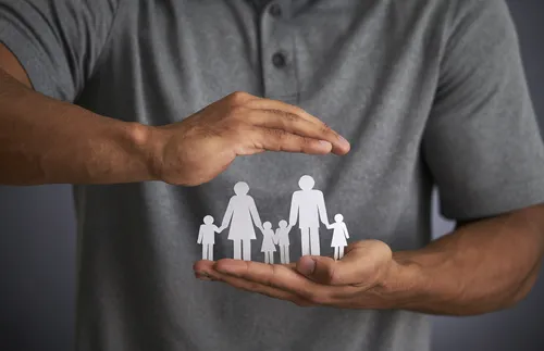 paper doll family with hand above and below