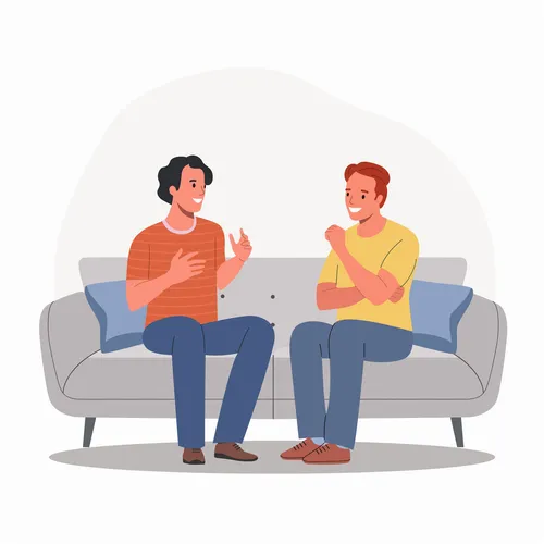 two men sitting on a couch and smiling and talking