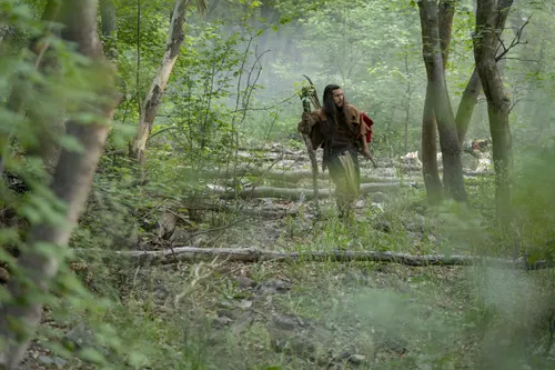 Enos hunts in the woods.