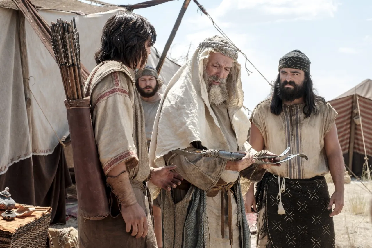 Nephi shows his broken bow to Lehi in the wilderness.