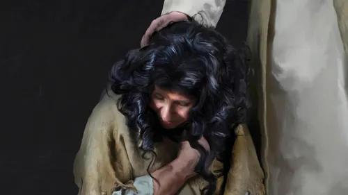 a woman with the Savior’s hand on her head