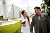 bride and groom in front of a temple