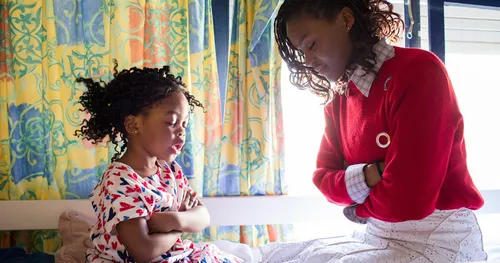 photo of mother and young daughter praying