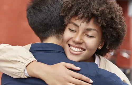 smiling woman embracing a man