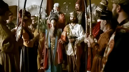 Queen Esther standing next to the king