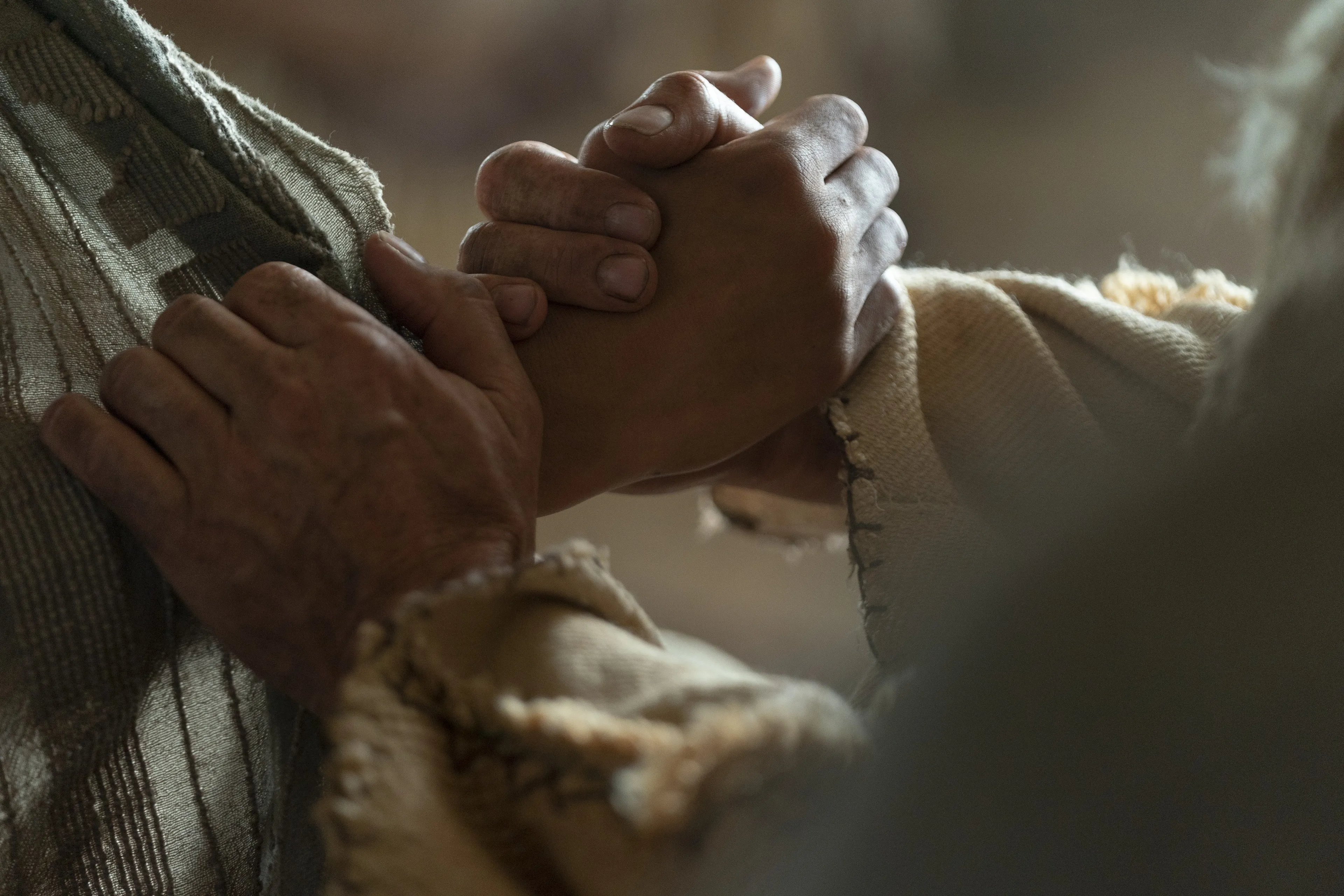 Lehi grasps Jacob's hand as he counsels with him.