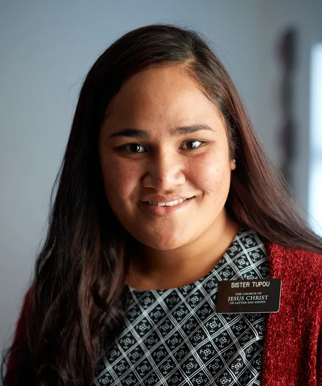 Various sister missionaries model appropriate dress and attire. They are wearing approved shirts. They appear to be talking to other people nearby.