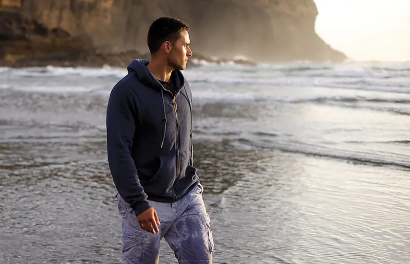A man walking on the beach contemplating repentance and forgiveness