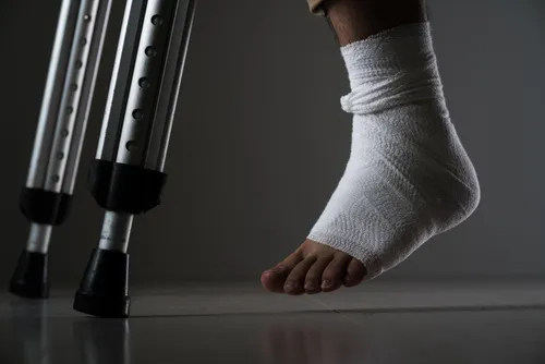 Person with hurt foot and crutches