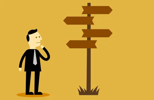 man standing by signpost and looking uncertain