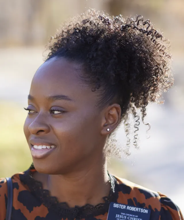 Various sister missionaries model appropriate dress and attire. They are wearing approved shirts.