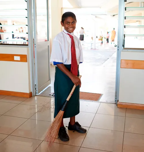 boy sweeping at church building