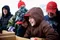 Boy Scouts in their winter coats gathering boxes for a food drive.