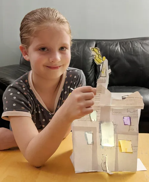 girl building 3D paper temple