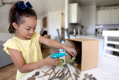 Child making a diorama craft