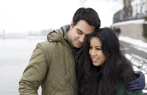 man with arm around woman