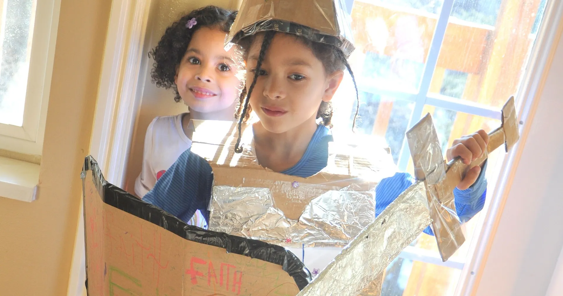 Children play dress up with armor