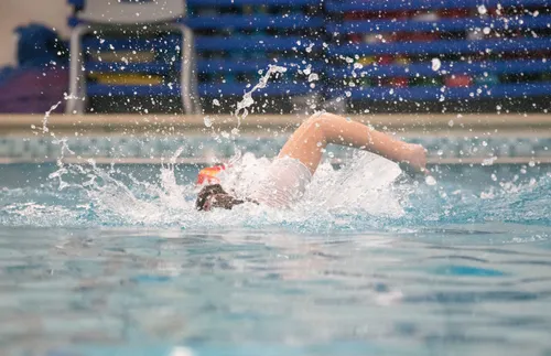 a woman swimming in a pool