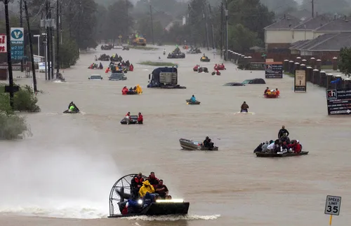 Flooded street with rescuers