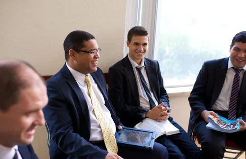 men in elders quorum smiling and laughing together