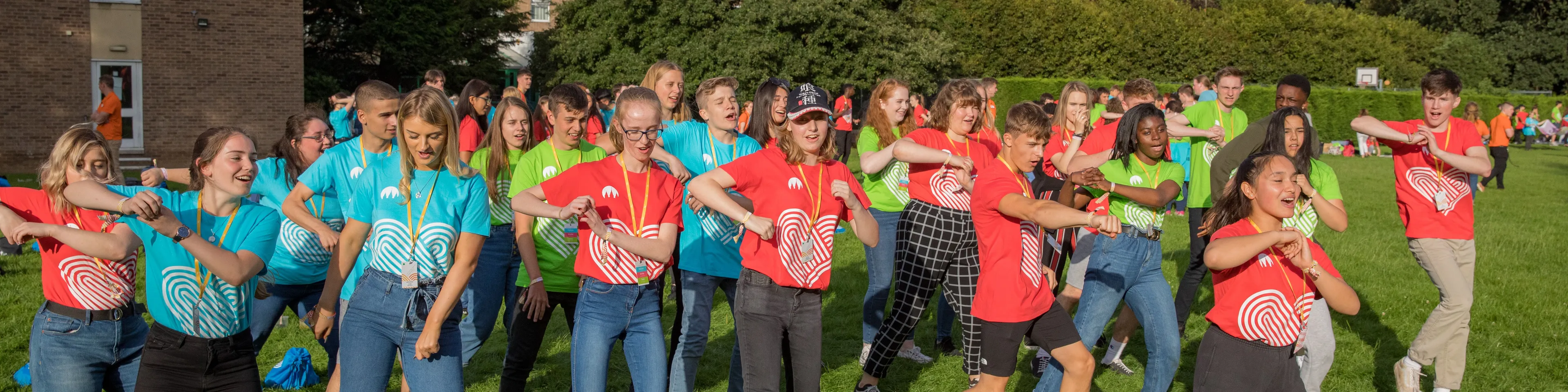 FSY staff and youth doing a FSY line dance as a group.