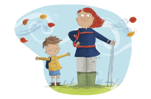 A woman and boy outside with leaves blowing in the wind