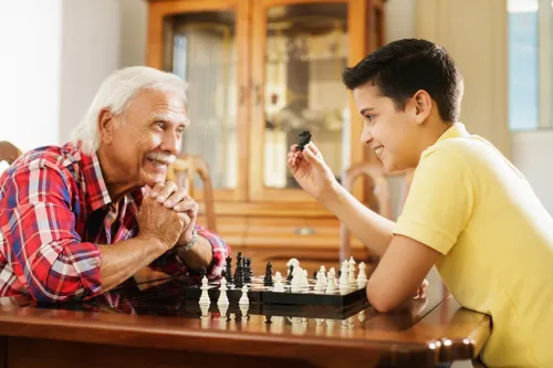 Grandfather and grandson playing chess