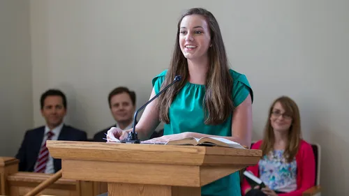 woman speaking over pulpit