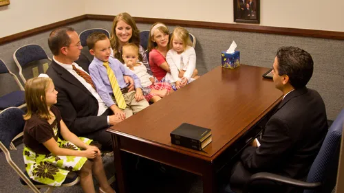 family talking to man