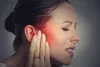 woman in pain touching her jaw