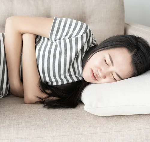 girl holding sore stomach