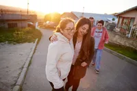 A family walks down a street enjoying the blessings of Jesus Christ