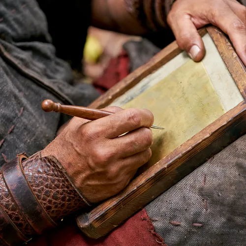 Moroni writing on plates