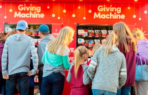 people in front of Giving Machines