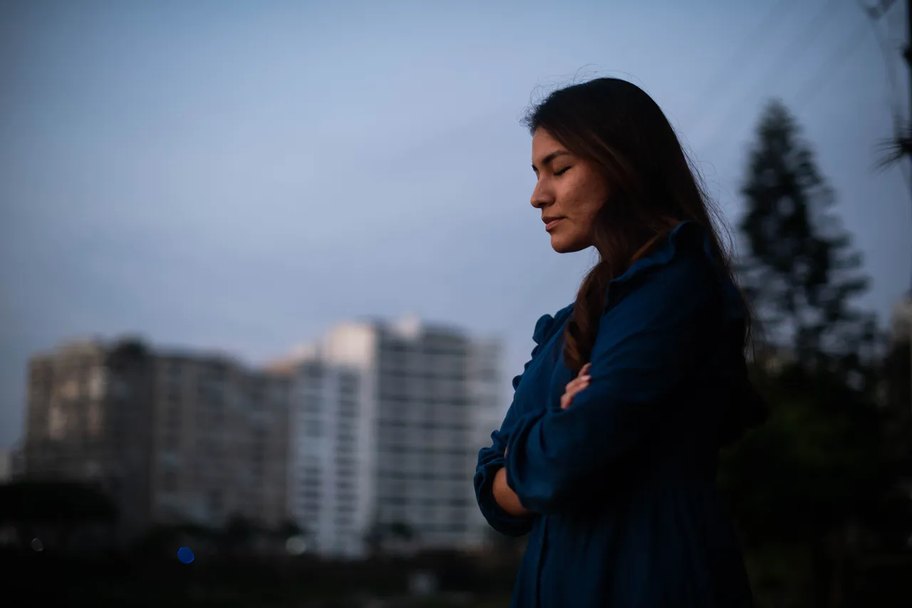 A woman prays outside