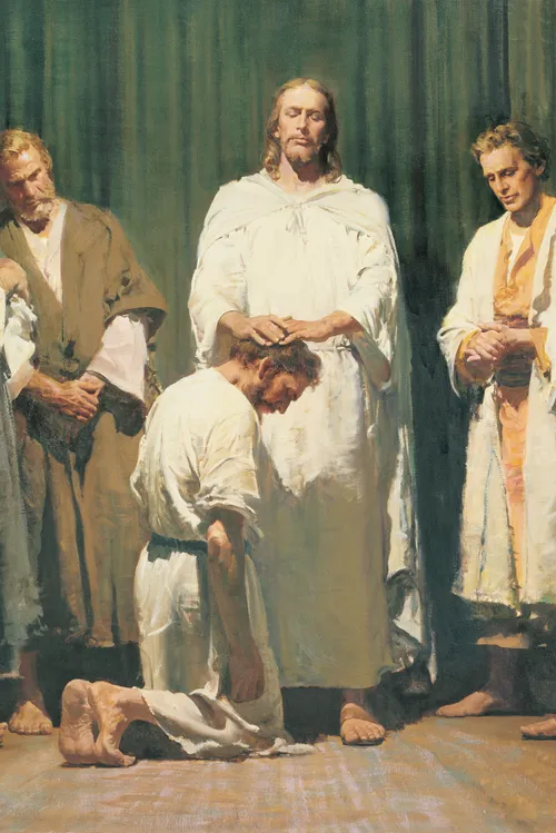 Christ with the twelve men chosen by Him to be His Apostles. Christ has His hands upon the head of one of the men (who kneels before Him) as He ordains the man to be an Apostle. The other eleven Apostles are standing to the left and right of Christ.