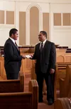 young man giving tithing to bishop