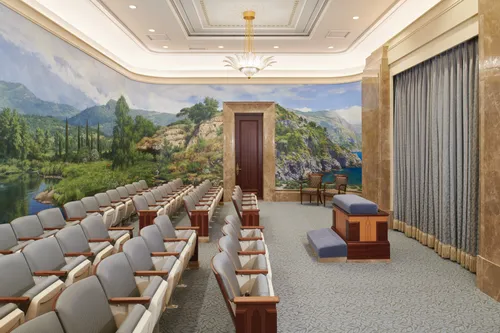 An instruction room in the Rome Italy Temple, with murals on the wall.