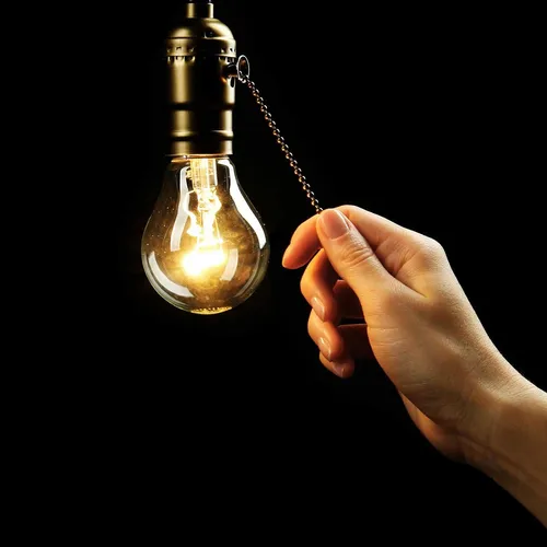 hand turning on a light